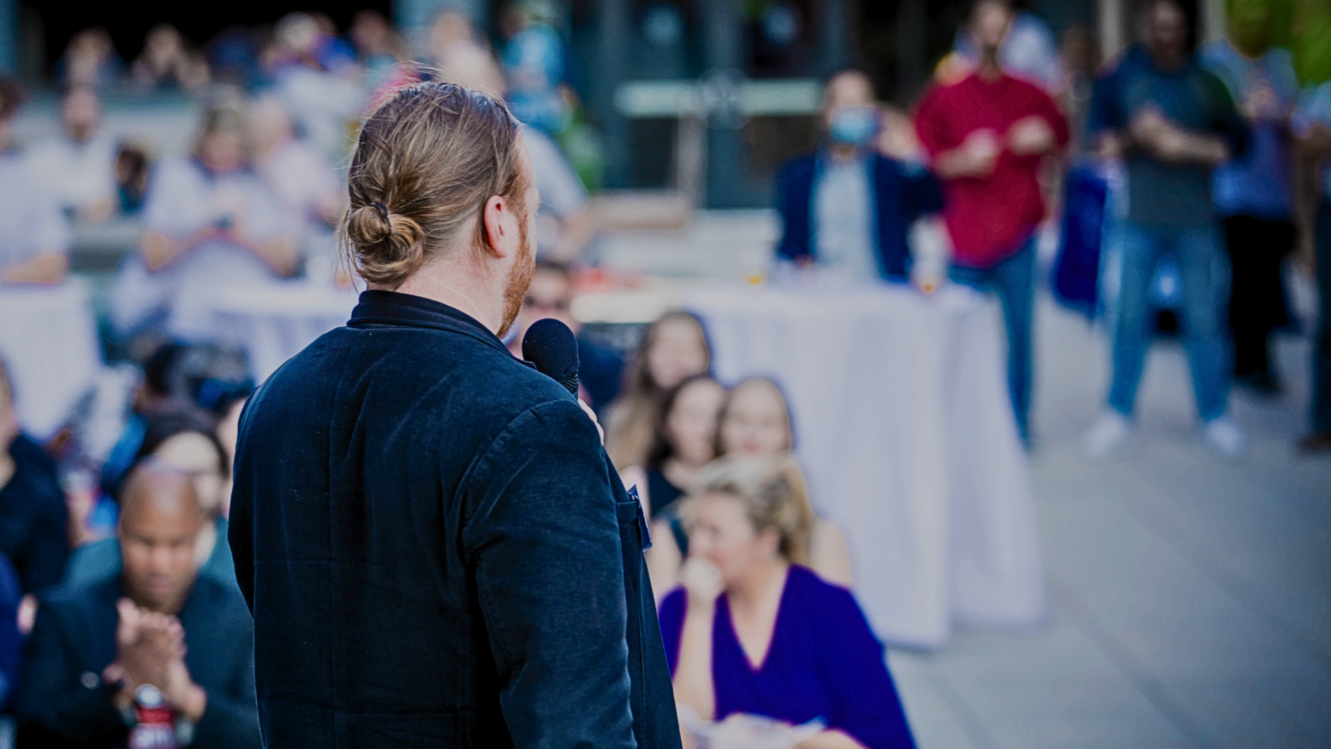 A man speaking at a public outdoor event